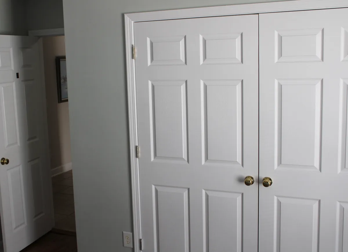 This image shows a set of double doors with light-colored walls and elegant door handles, suggesting an entrance or transition point within the villa. The scene hints at the excitement of stepping out to explore what lies beyond, tying into the anticipation of discovering local attractions.
